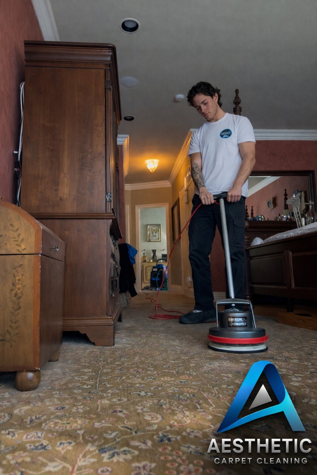 Aesthetic team rotary cleaning a patterned carpet